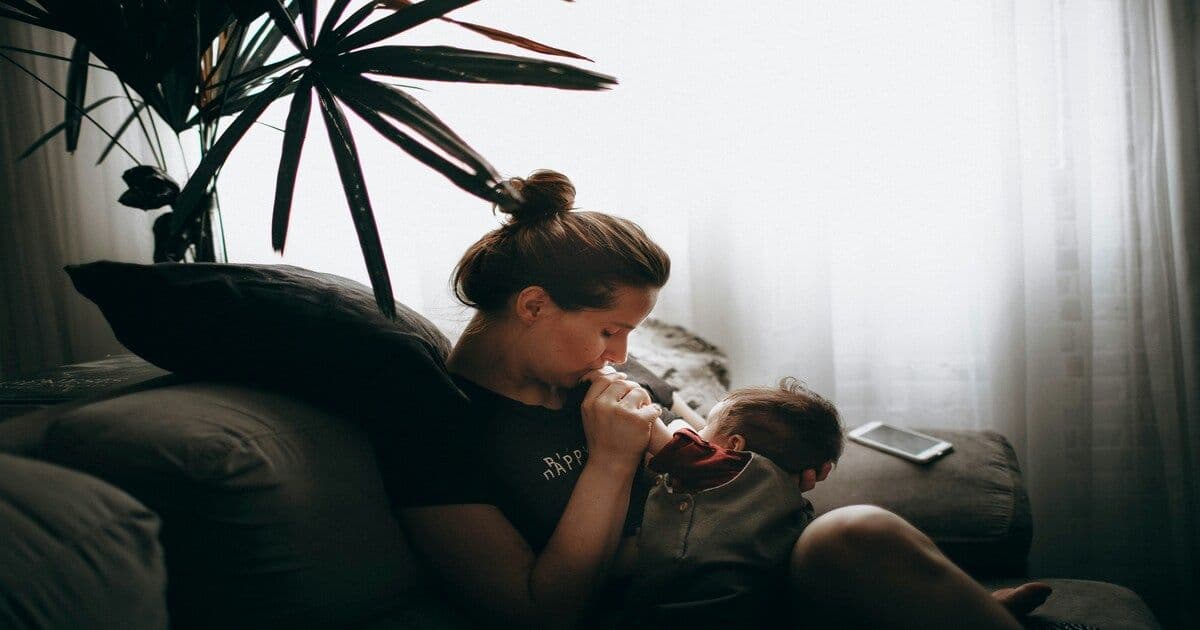 a woman gently holding her baby