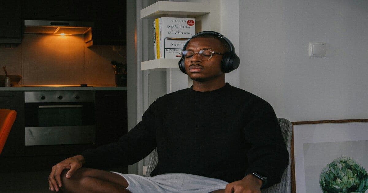 A man sitting quietly with his eyes closed,