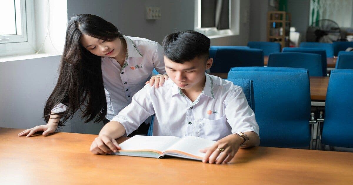 A student receiving guidance and support from a woman, symbolizing mentorship and care.