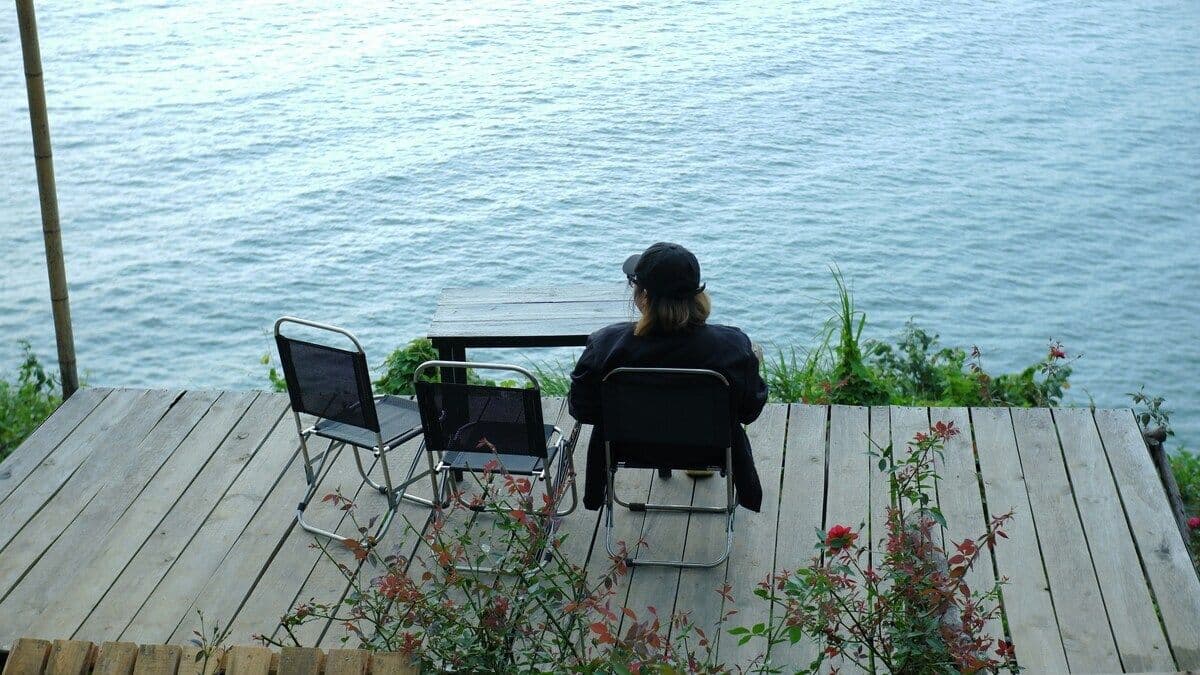 Person sitting peacefully surrounded by nature