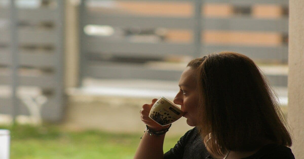 A woman relaxing with a cup of coffee.