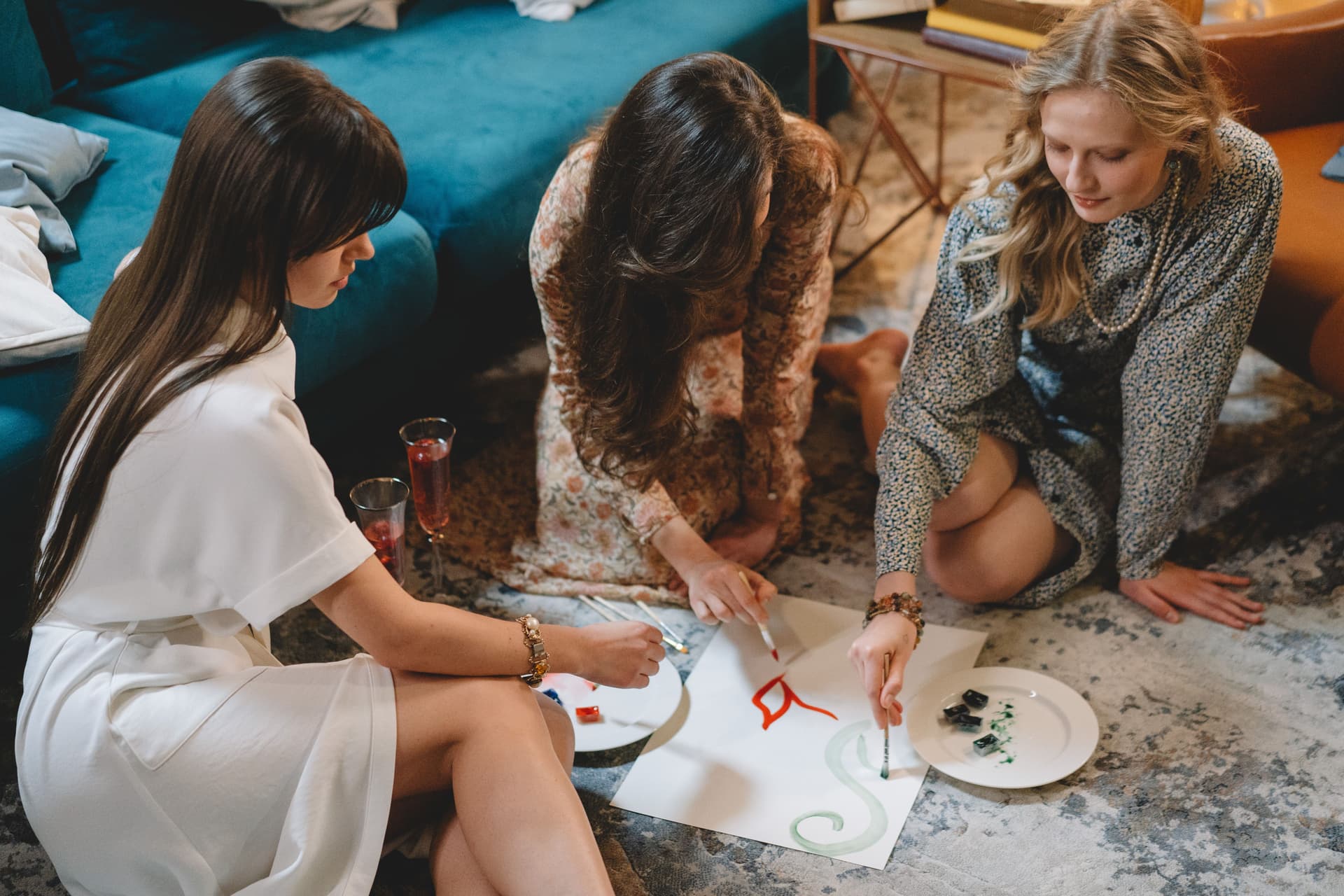 Three women taking part in an art activity during an expressive therapy session.